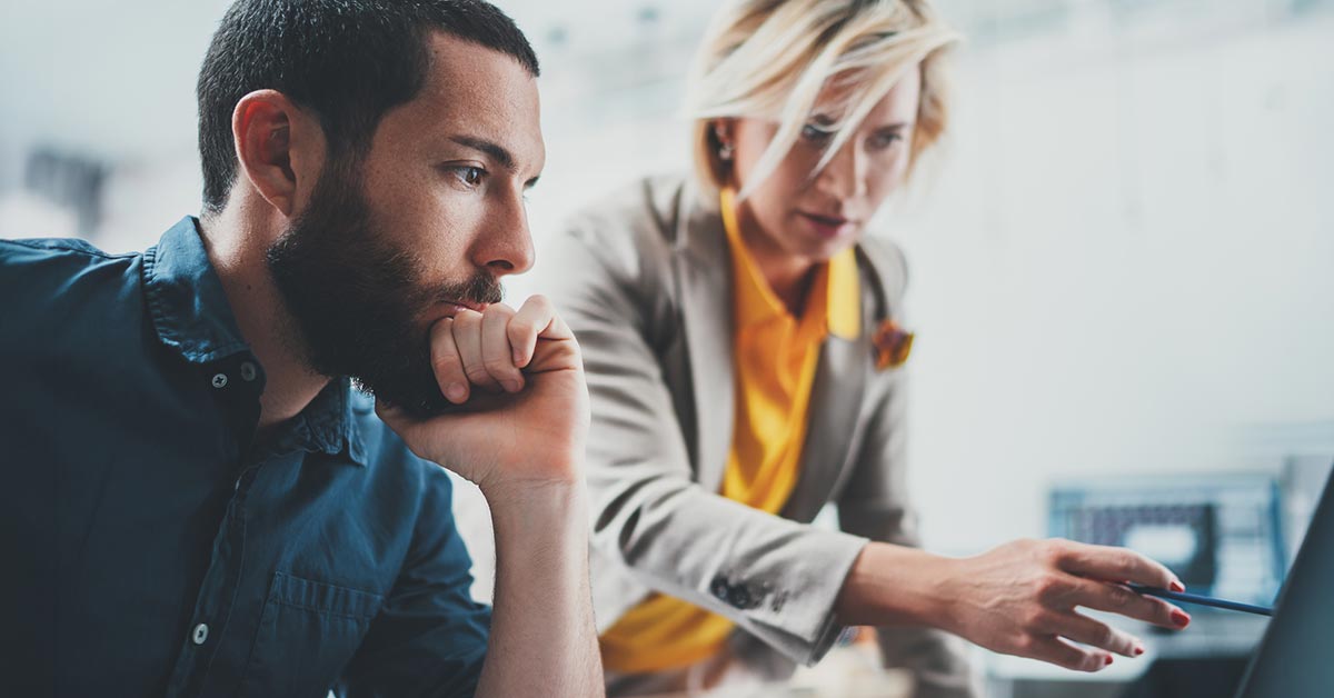 Two people working on an IT issue